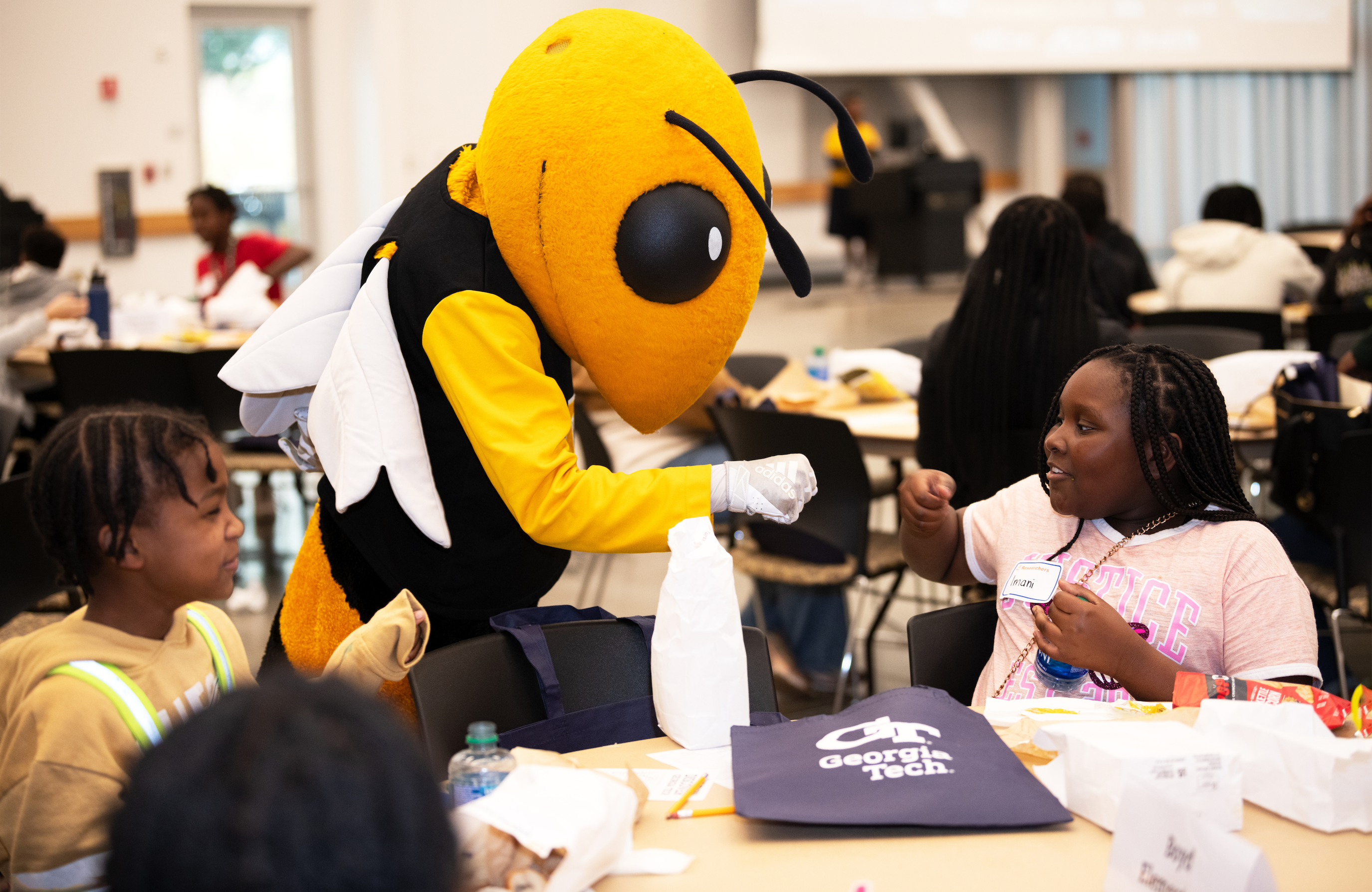 Child fist-bumping mascot