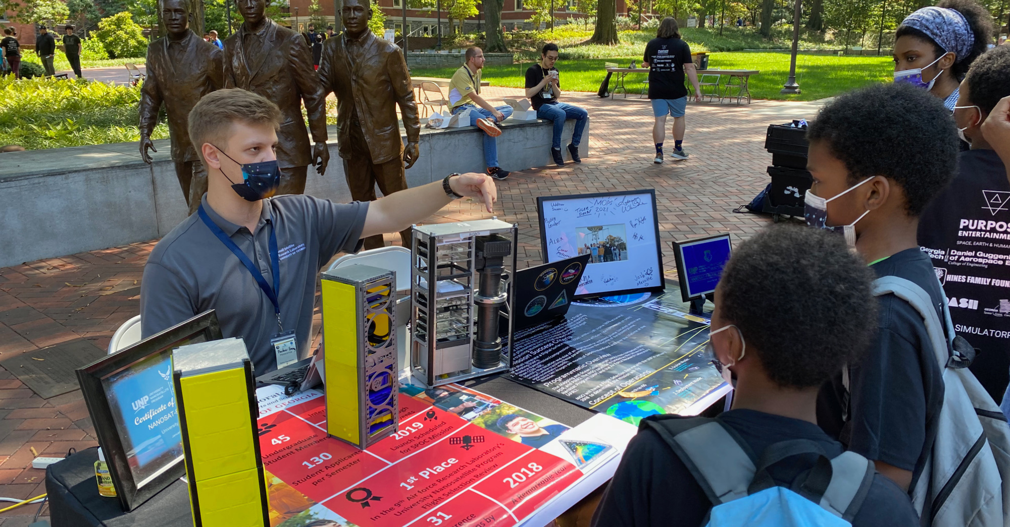 Younger students talking to college student